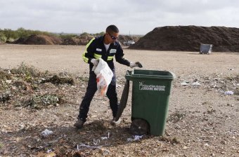 Organic Monitor Larry Rosalez sorts through organic material picked up by the City of San Antonio Solid Waste Department at the New Earth Soils and Compost facility at 7800 East IH-10, Tuesday, August 18, 2015. Rosalez takes out inorganics, such as plastics and bottles, from the material that is turned into compost. The city is offering its residents lower rates for garbage service by letting them recycle more of their waste for a lower bill under a program called,